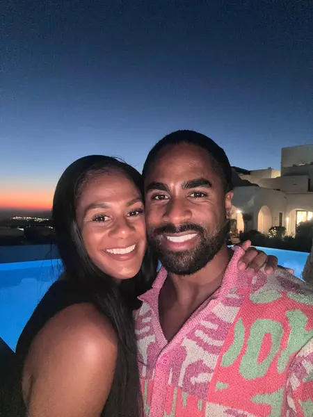 Shaun and Rebekah together by a pool at sunset